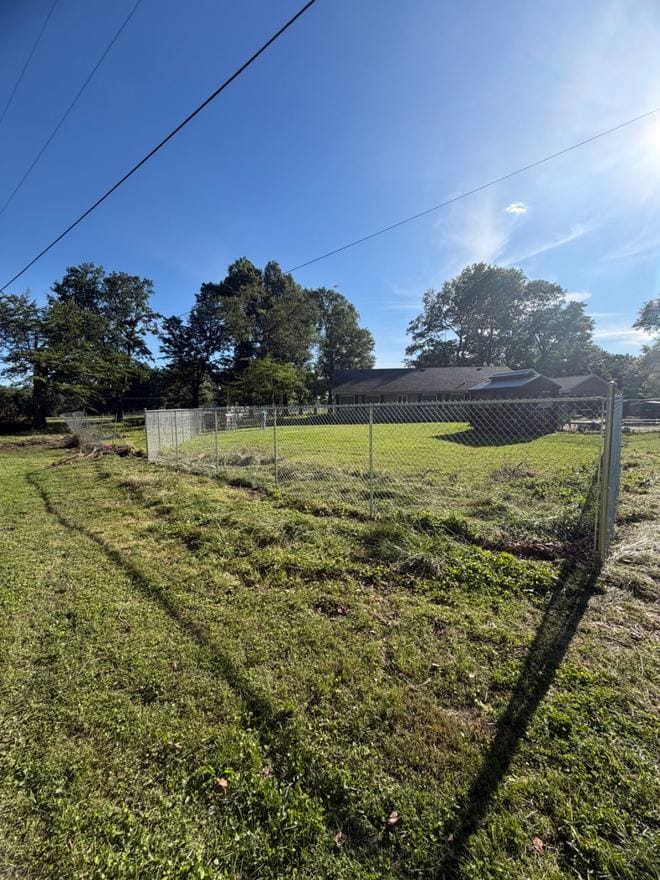 Chain link fence line across an open field