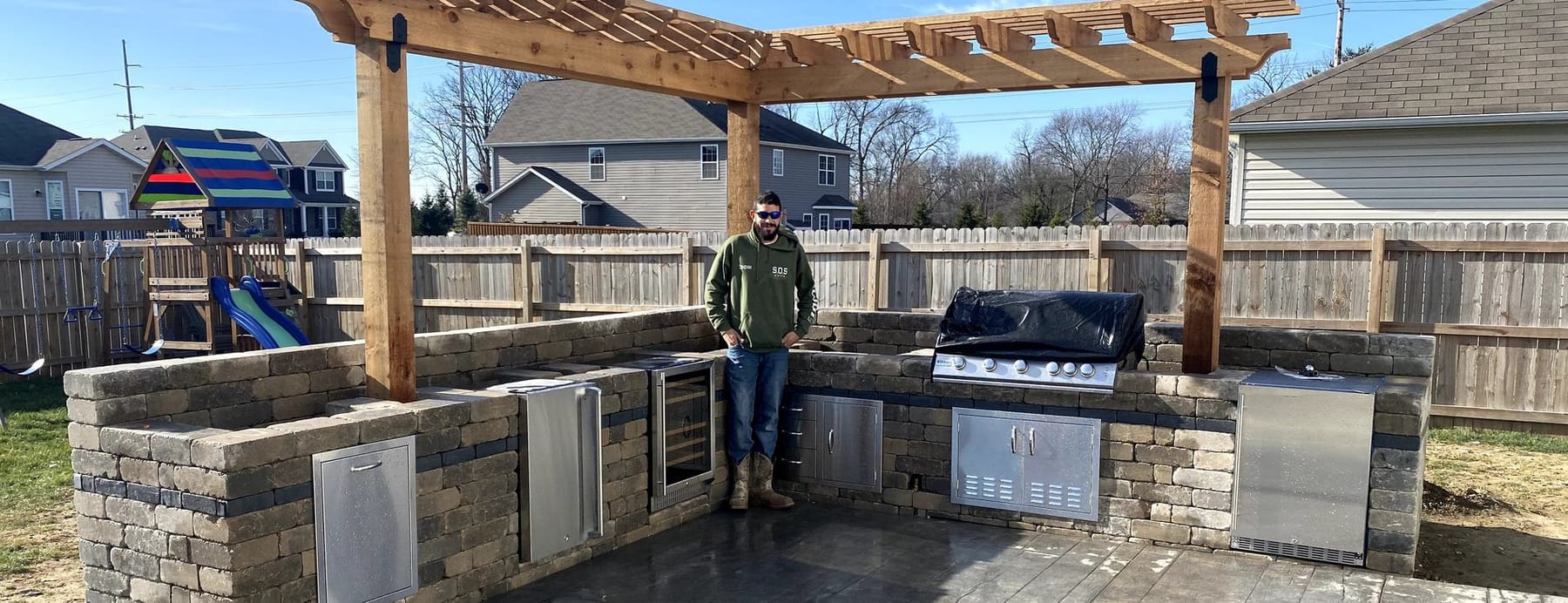 Pergola over an outdoor kitchen on a finished patio
